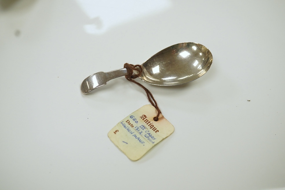 A pair of George III bright cut engraved Old English pattern table spoons, by John Lambe, London 1782, 21.1cm, together with two 19th century silver caddy spoons, a George III silver marrow scoop and a late Victorian sil